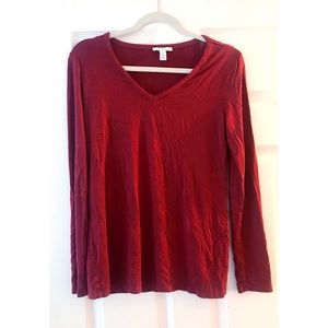 Long sleeve loose fitting red T-shirt.